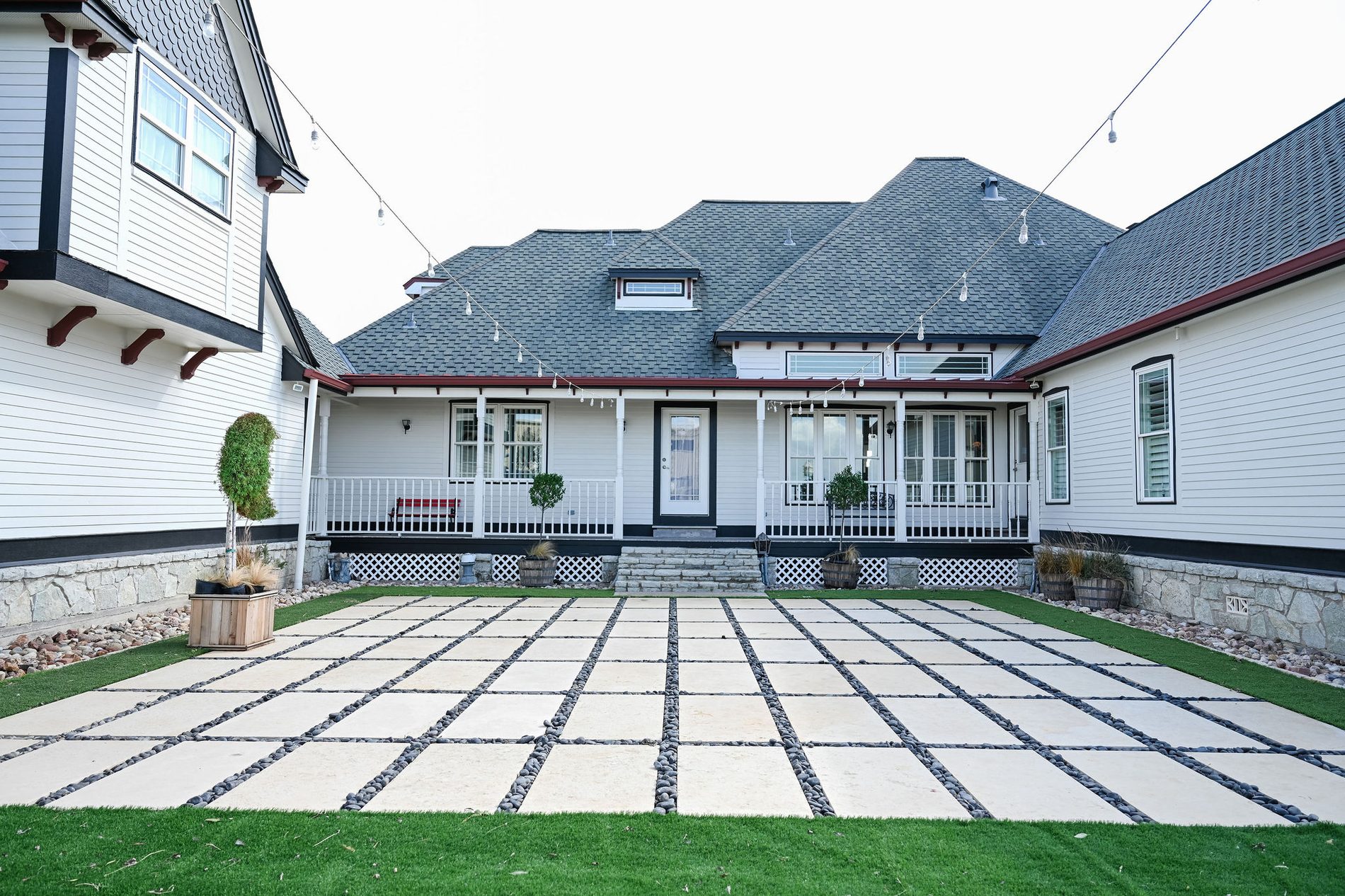 The ranch house courtyard with string lights over the patio