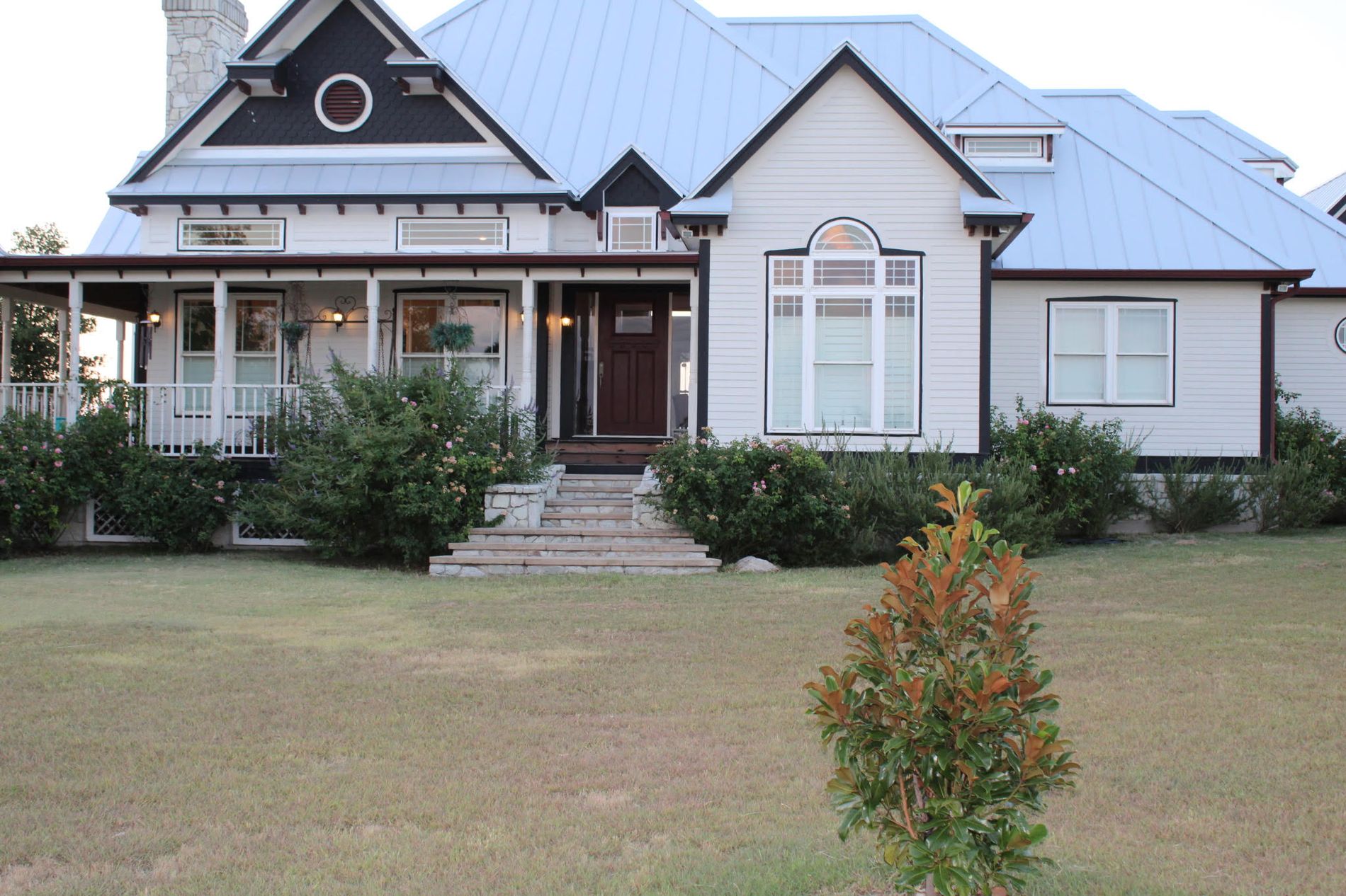 The front of the ranch house, white with black trim