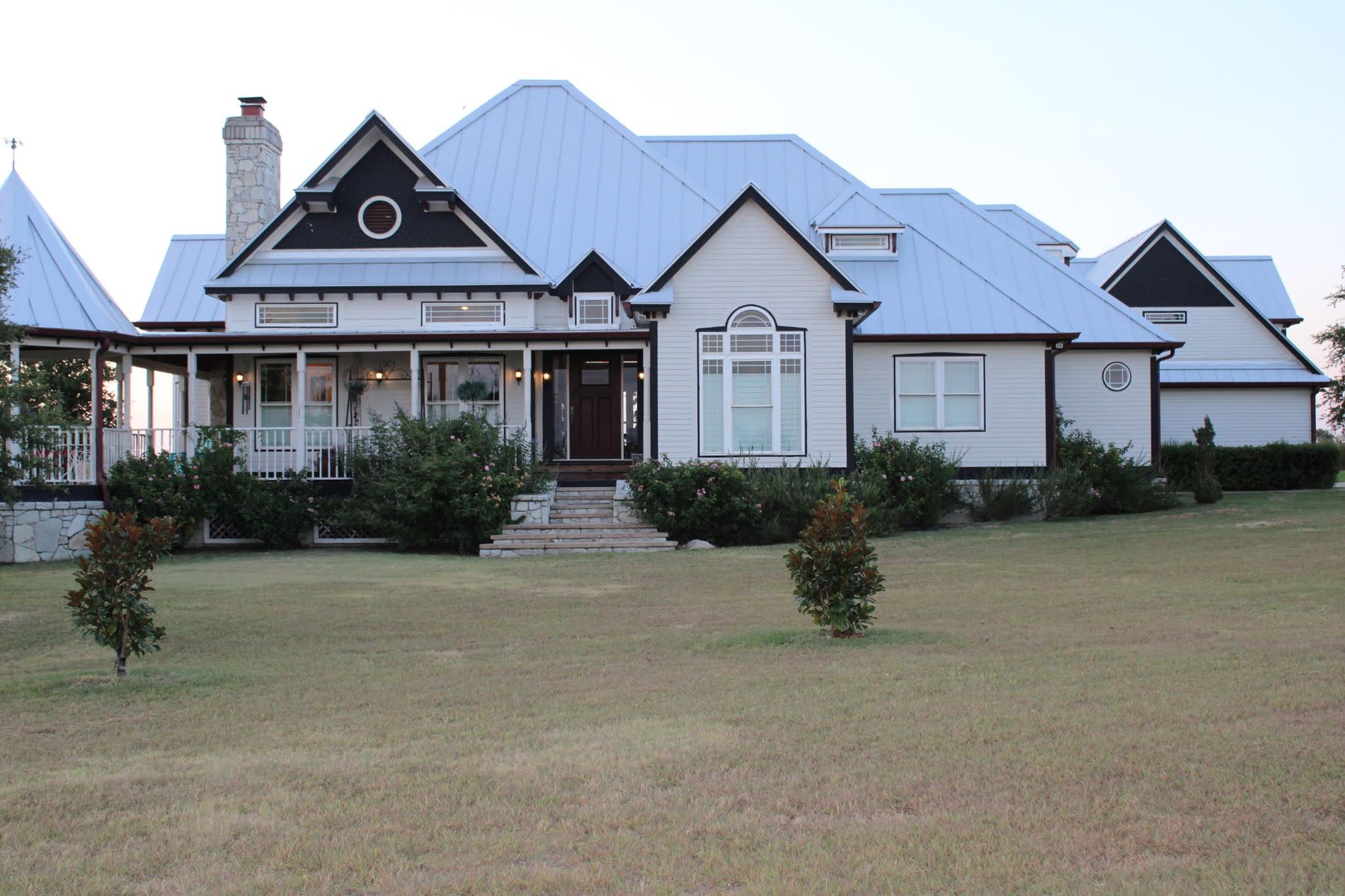 The ranch house, white with the tin roof
